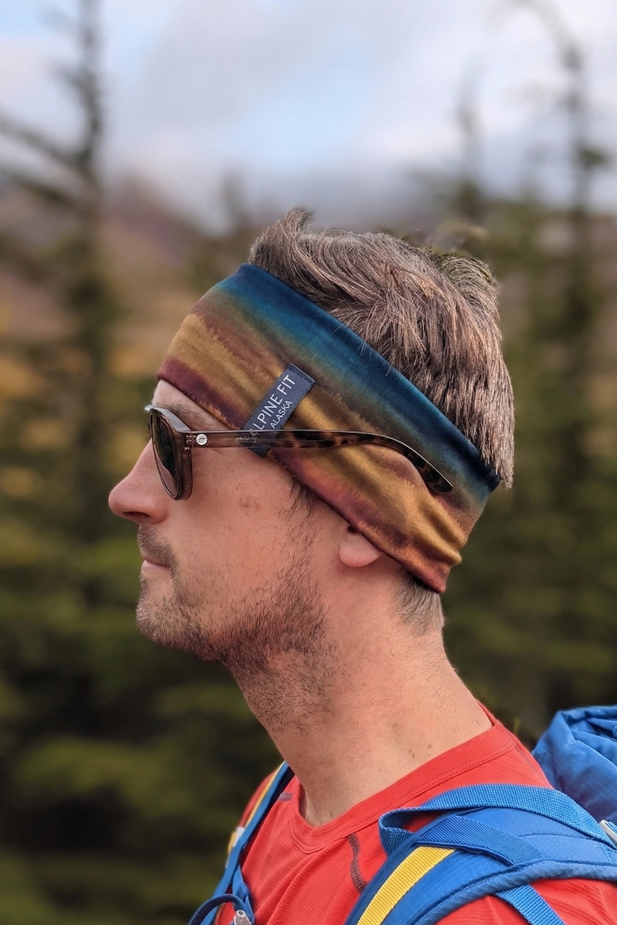 Alpine Fit Merino Wool Lined Headband grasslands color on man, Half left side view, Outdoors blurry background