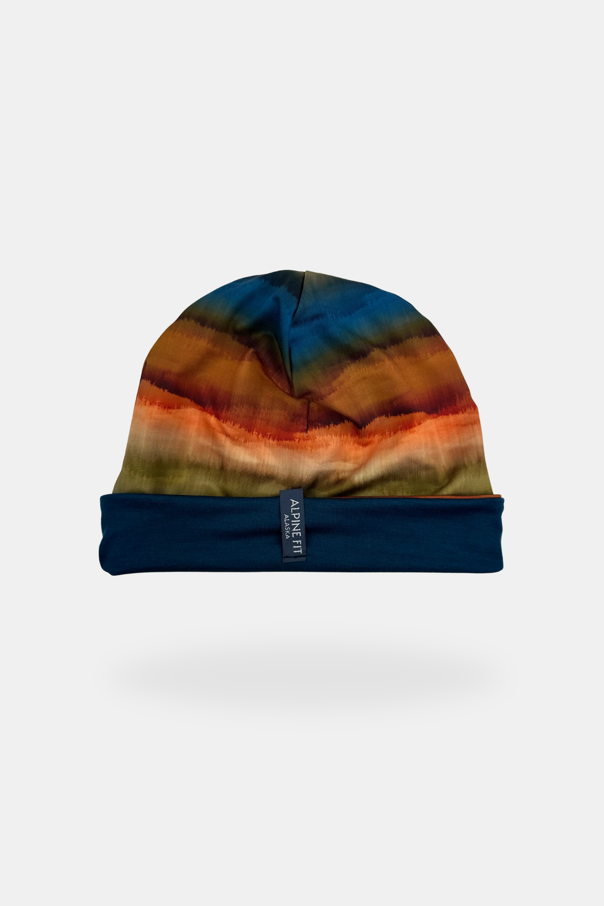 Alpine Fit Go All Winter Merino Wool Hat Grasslands, Colorful tie-dye beanie with blue interior on a white background