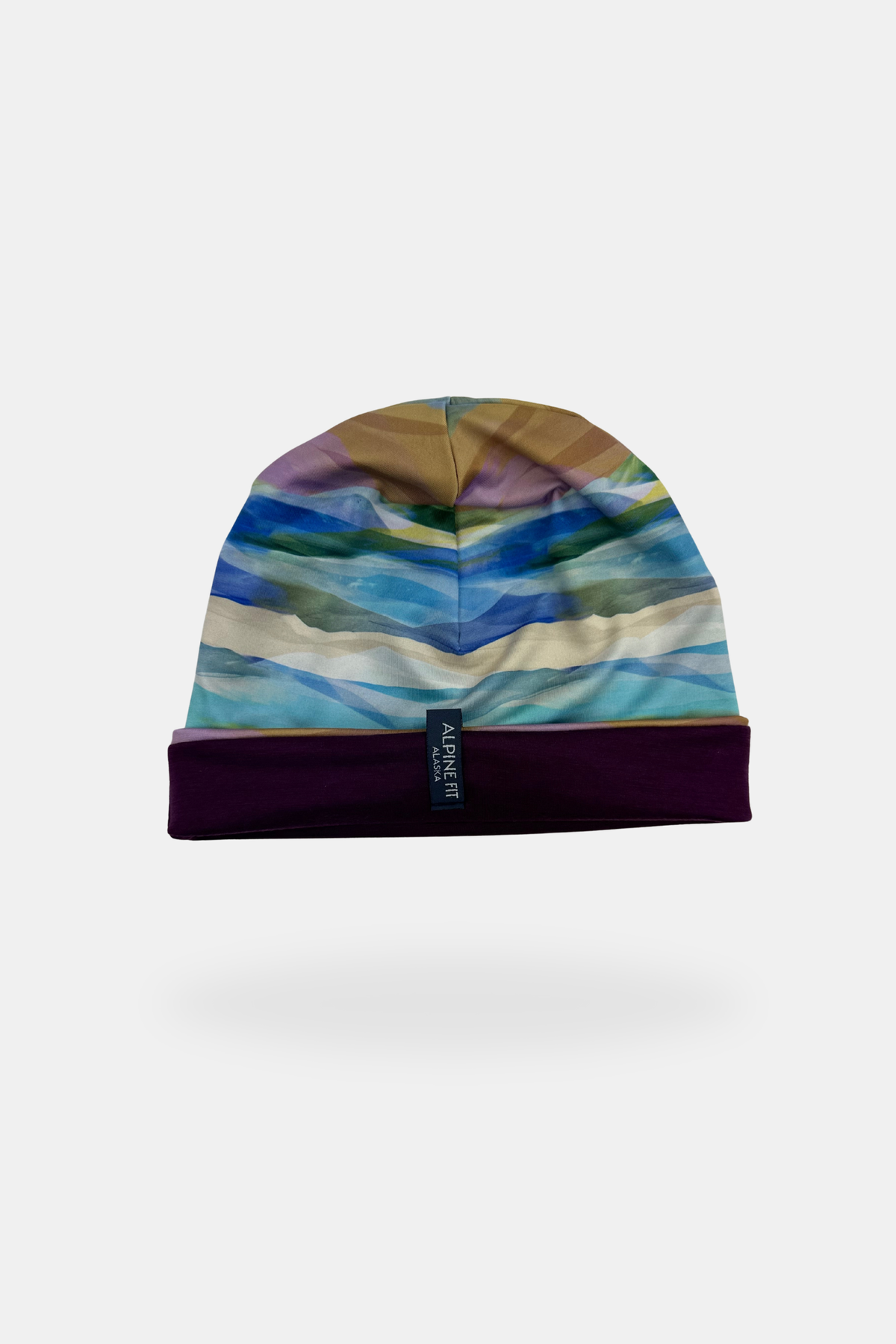 Alpine Fit Go All Winter Merino Wool Hat Rainbow Peak, Colorful striped beanie on a white background