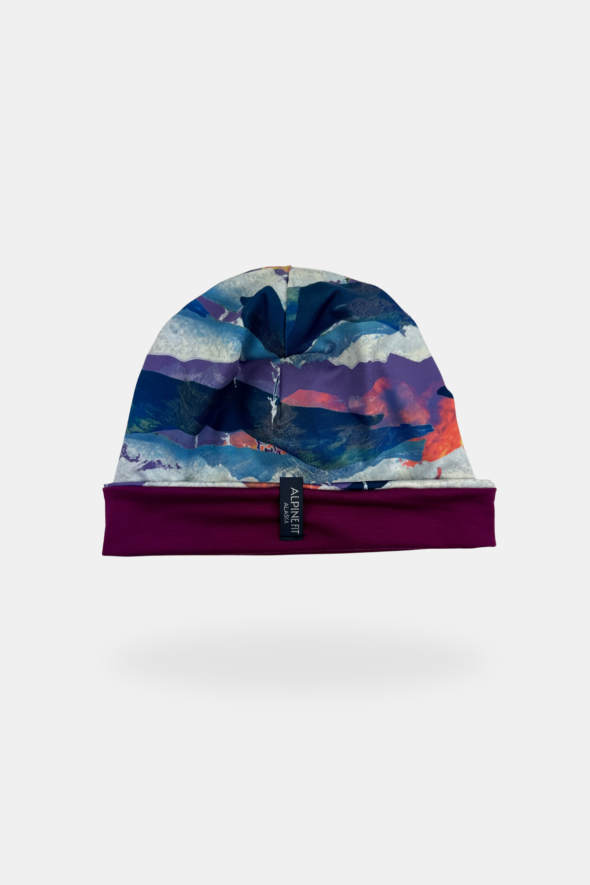 Alpine Fit Go All Winter Merino Wool Hat Sunrise, Colorful beanie with abstract design on a white background