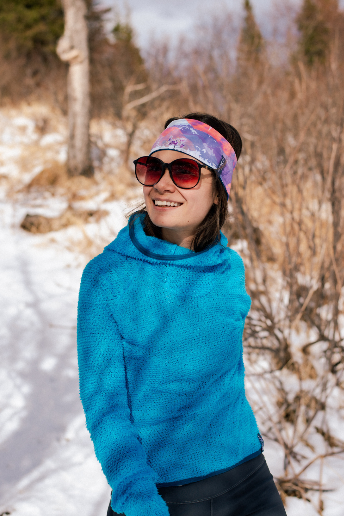 Alpine fit Merino wool lined headband sunrise on woman, half view, snowy background