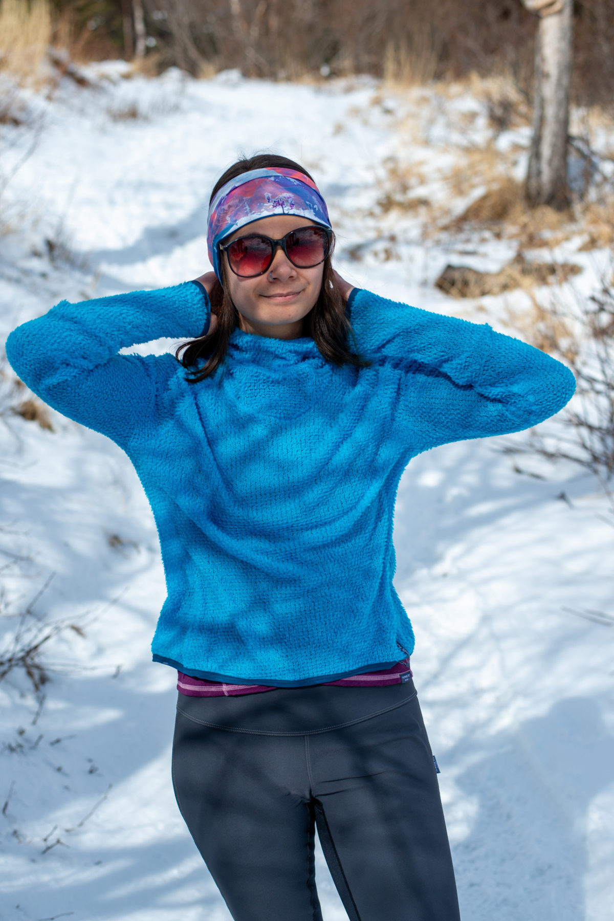 Alpine fit Merino wool lined headband sunrise on woman, full view, snowy background