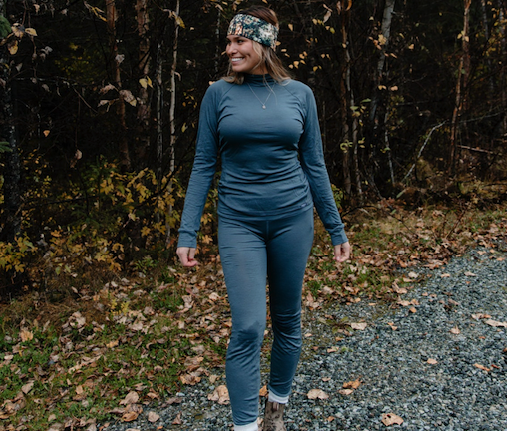 Woman wearing merino wool base layer top and bottoms