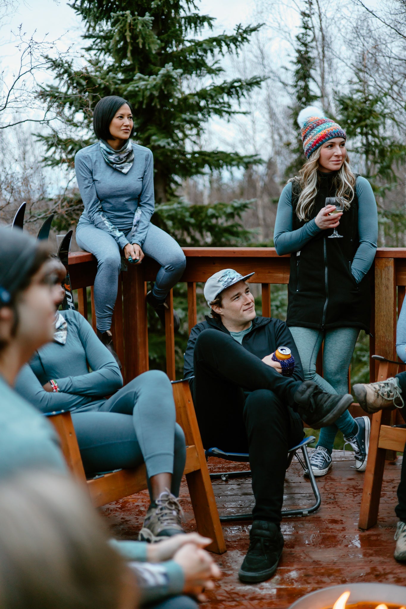 alpine fit base layers on multiple models around a camp fire