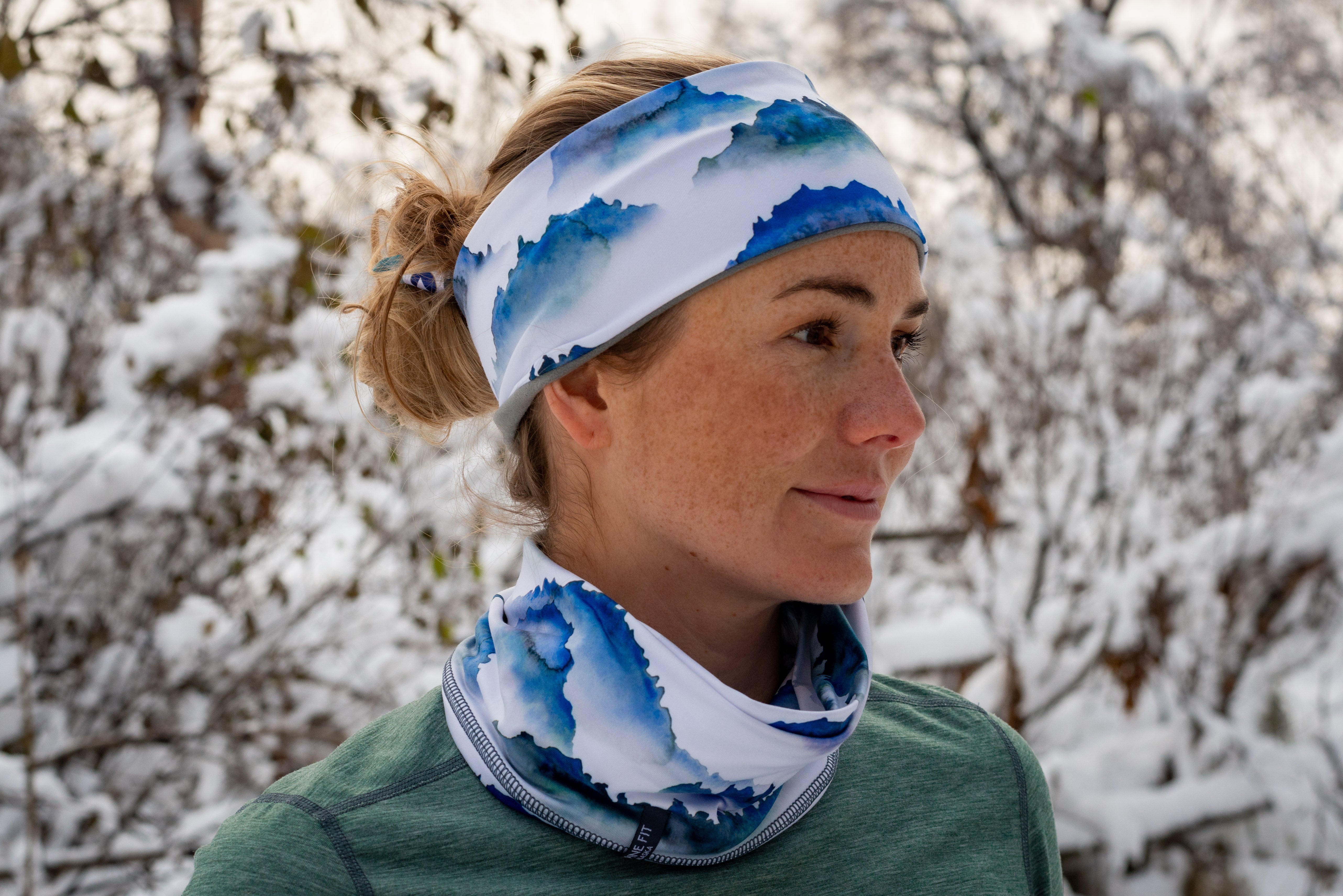 alpine fit fleece headband mountain print on model outside