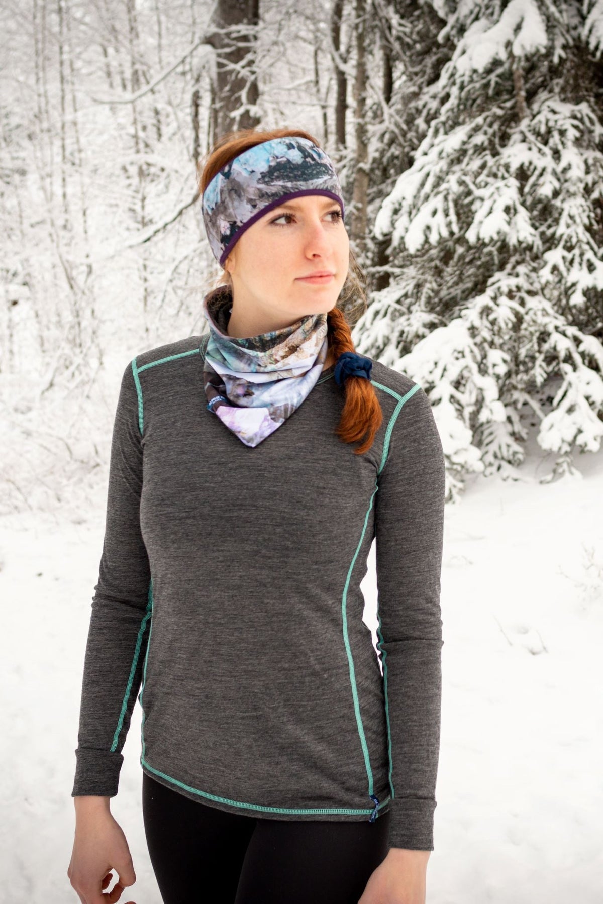 alpine fit neck gaiter on model outside with headband and base layer top