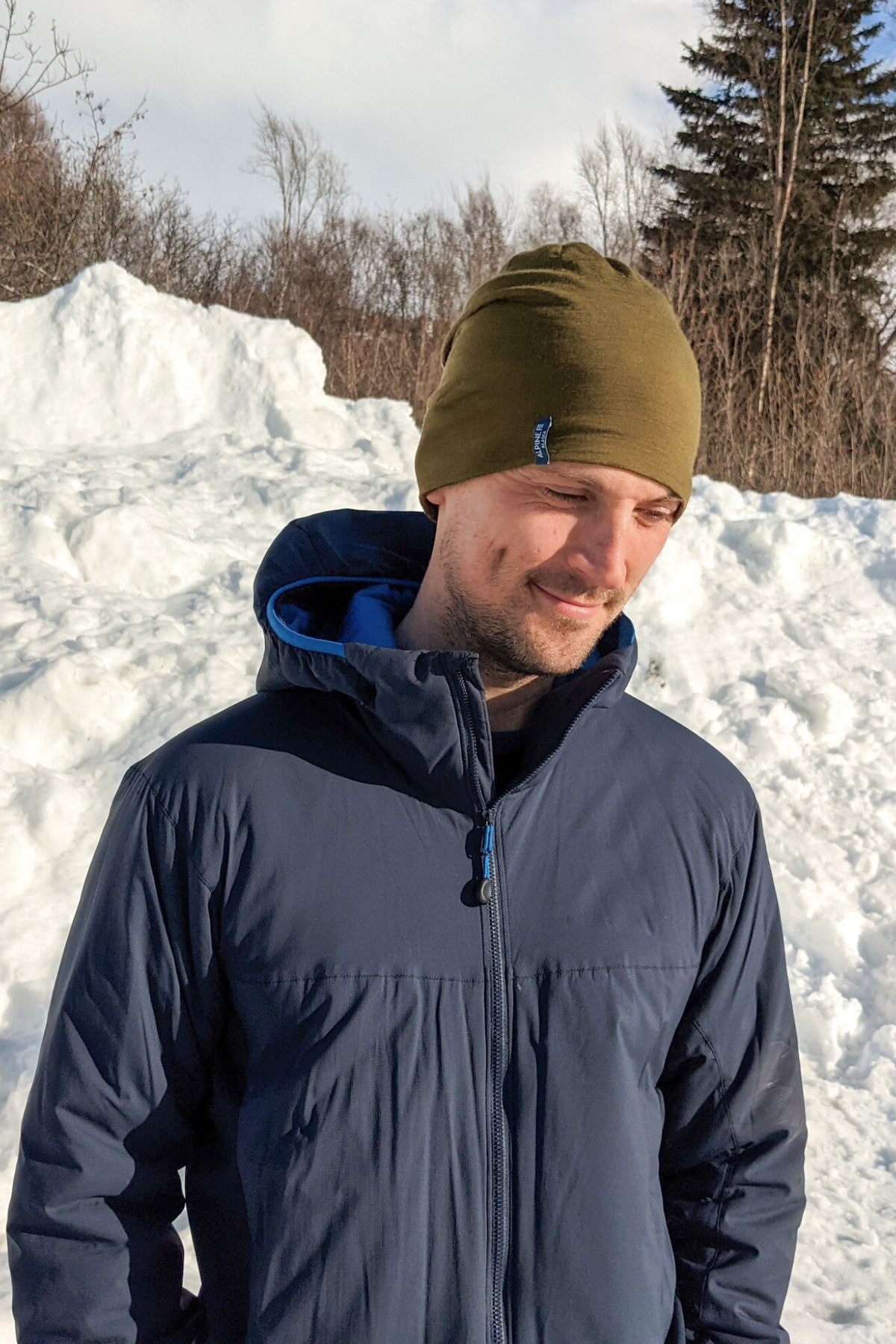 Alpine fit Nordic anywhere merino wool hat kelp green on man, Half view, snowy background