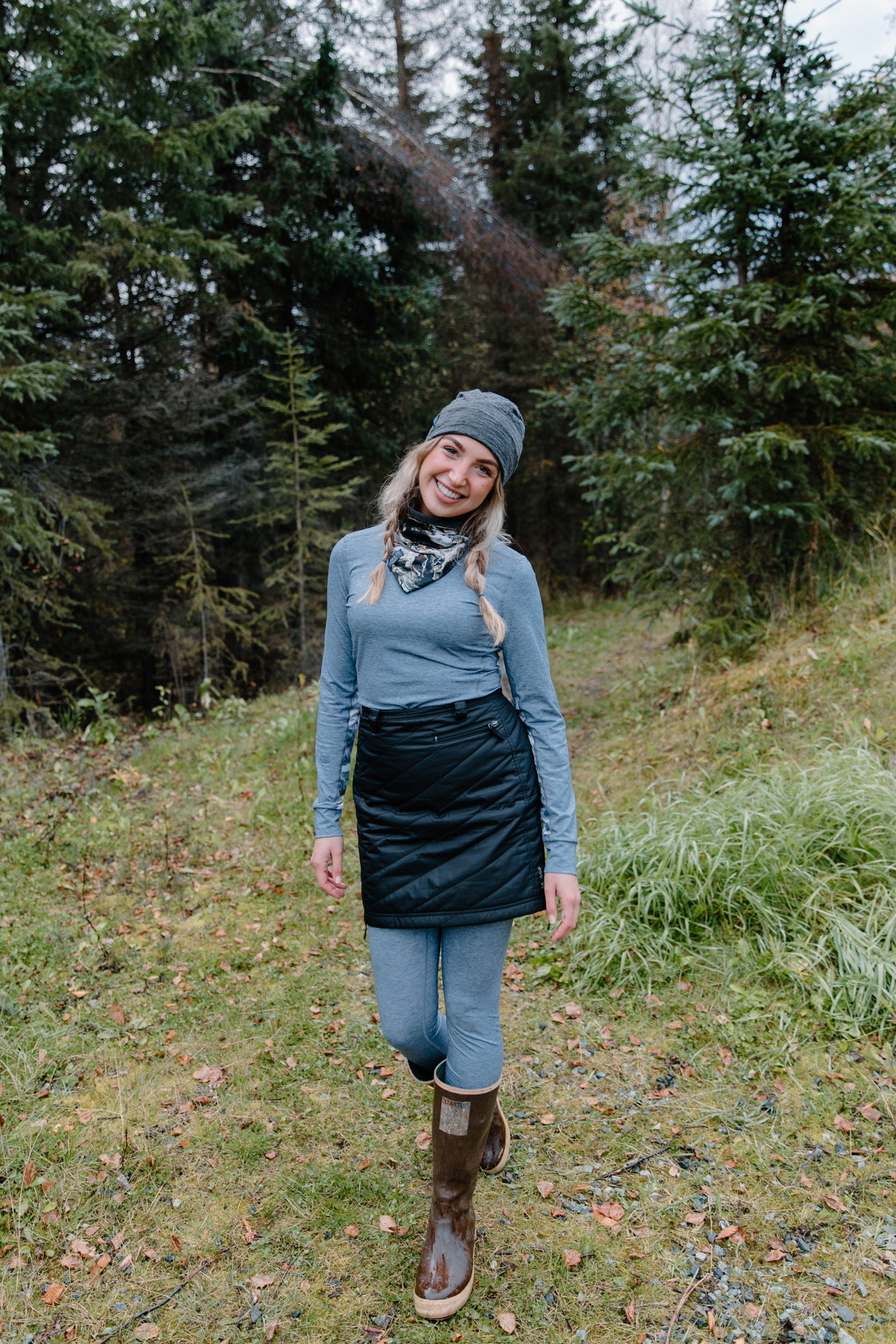 alpine fit blue base layer top and bottom on model outside with hat and neck gaiter