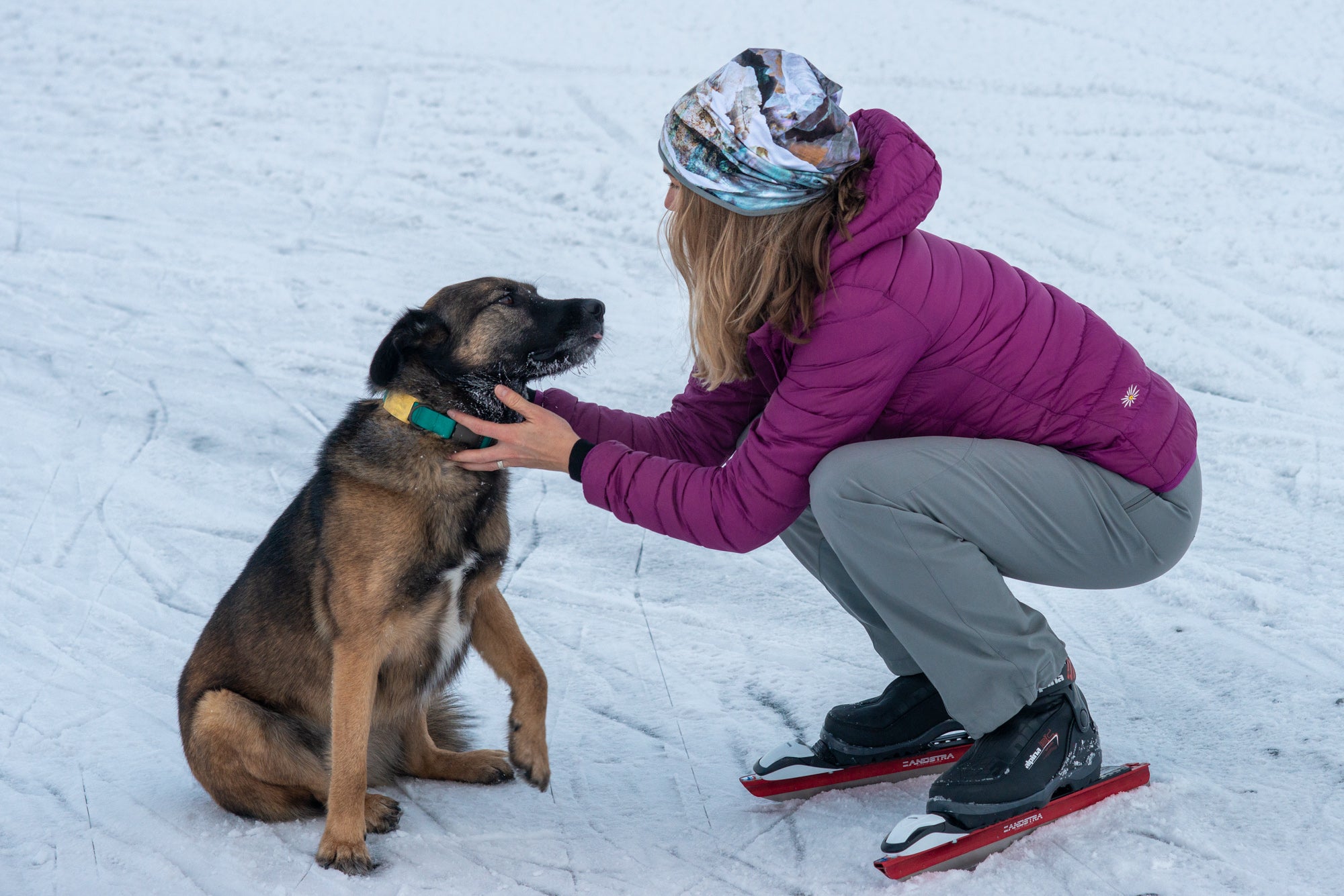 alpine fit fleece hat on model outside skating with dog