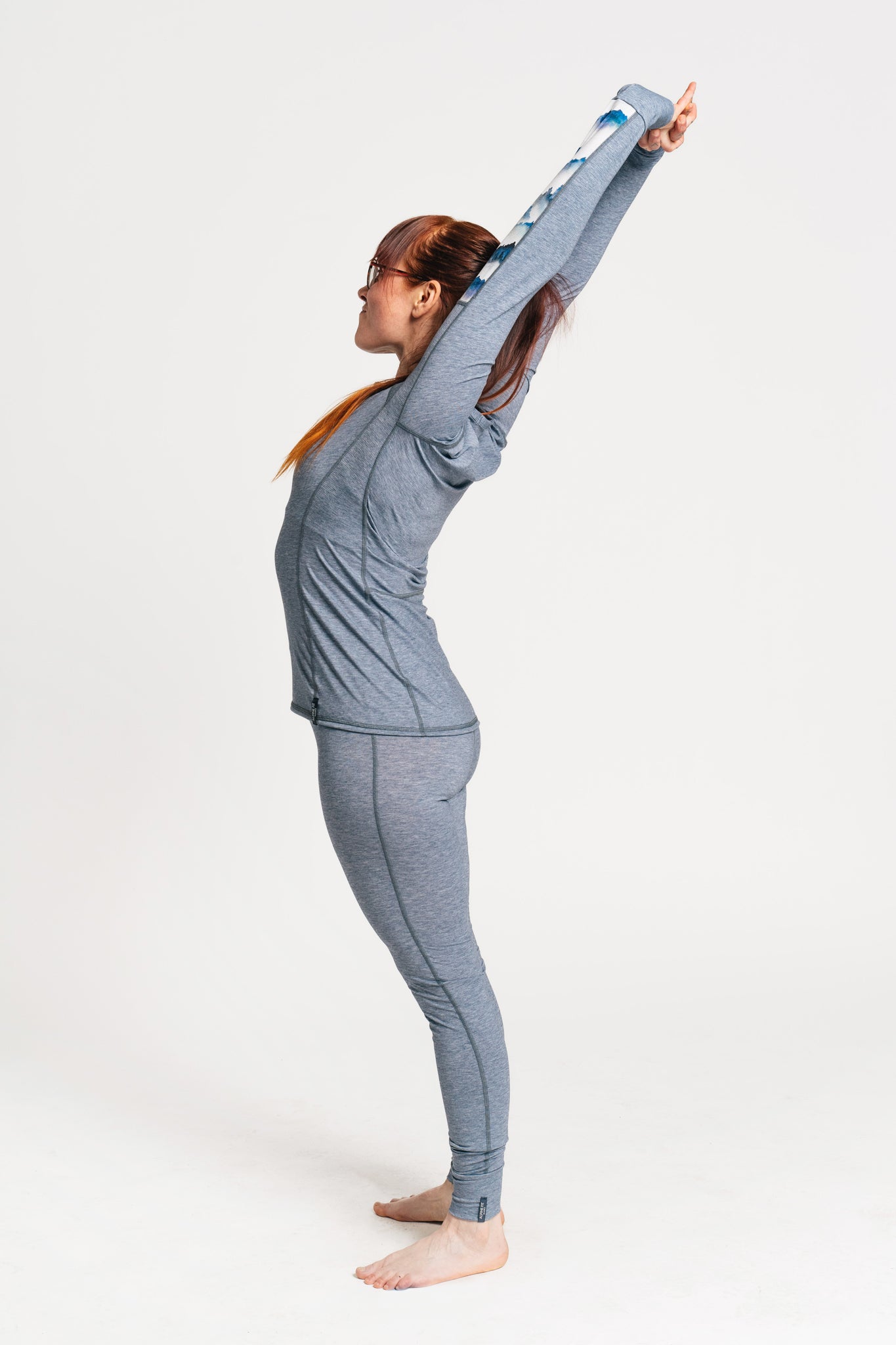 alpine fit blue base layer top and bottom with model viewed from the side