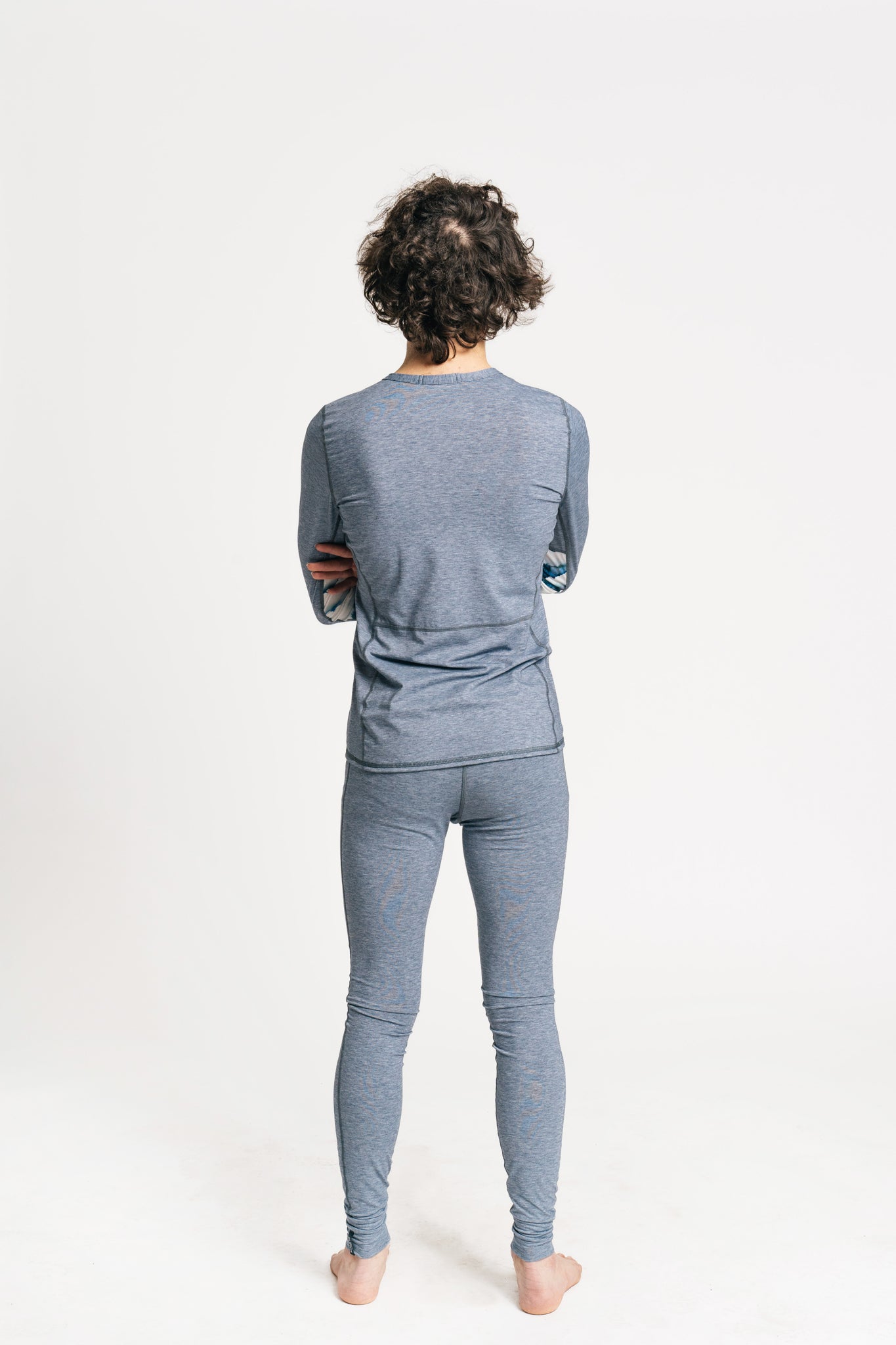 alpine fit men blue base layer top and bottom on model viewed from the back