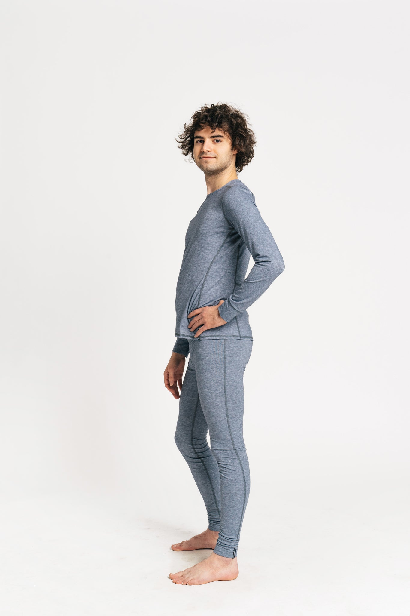 alpine fit men blue base layer top and bottom on model viewed from the side