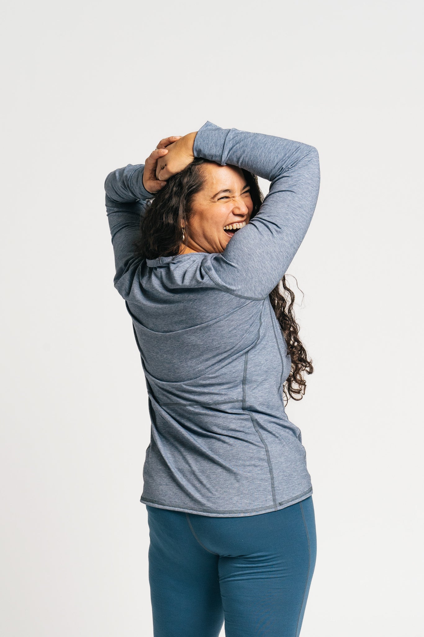alpine fit long sleeve base layer blue on model back view smiling