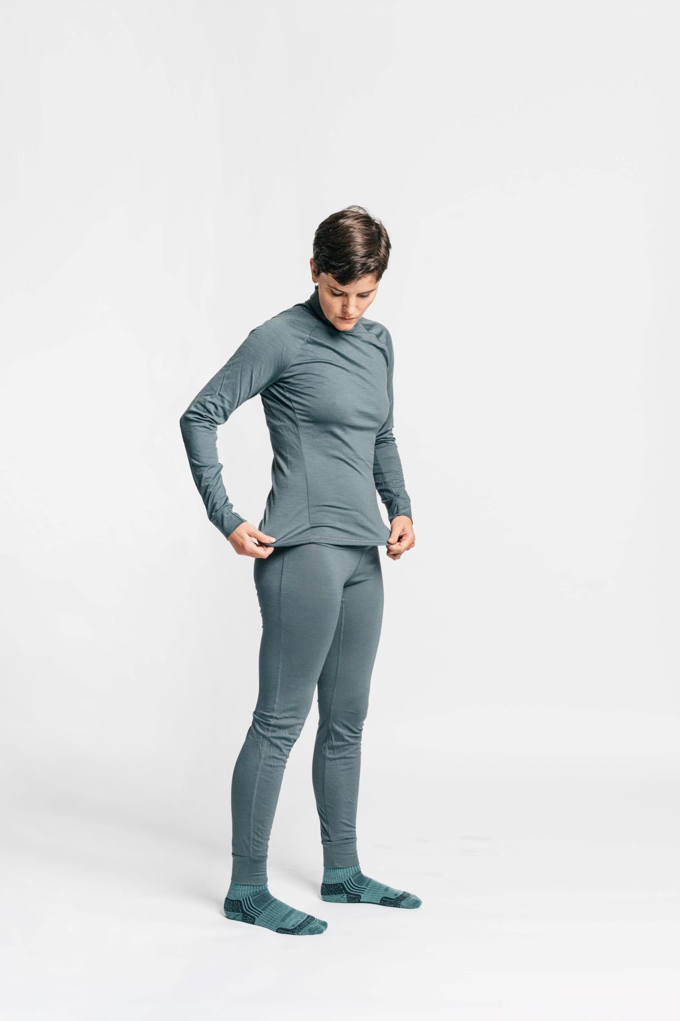alpine fit merino wool base layer top and bottom on model side view