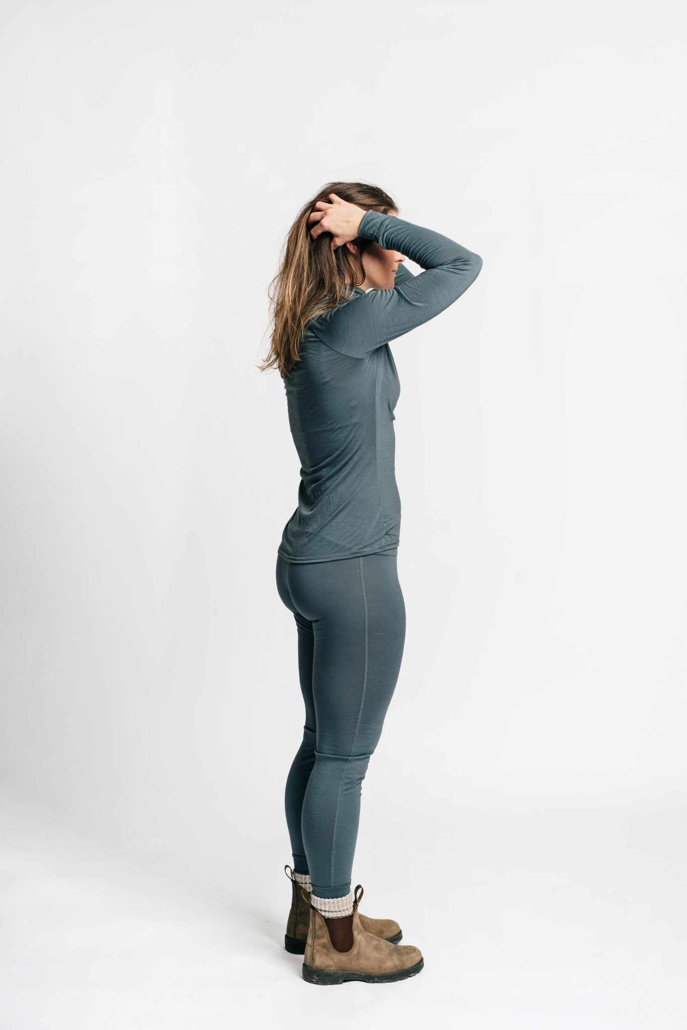 alpine fit merino base layer top and bottom on model from side