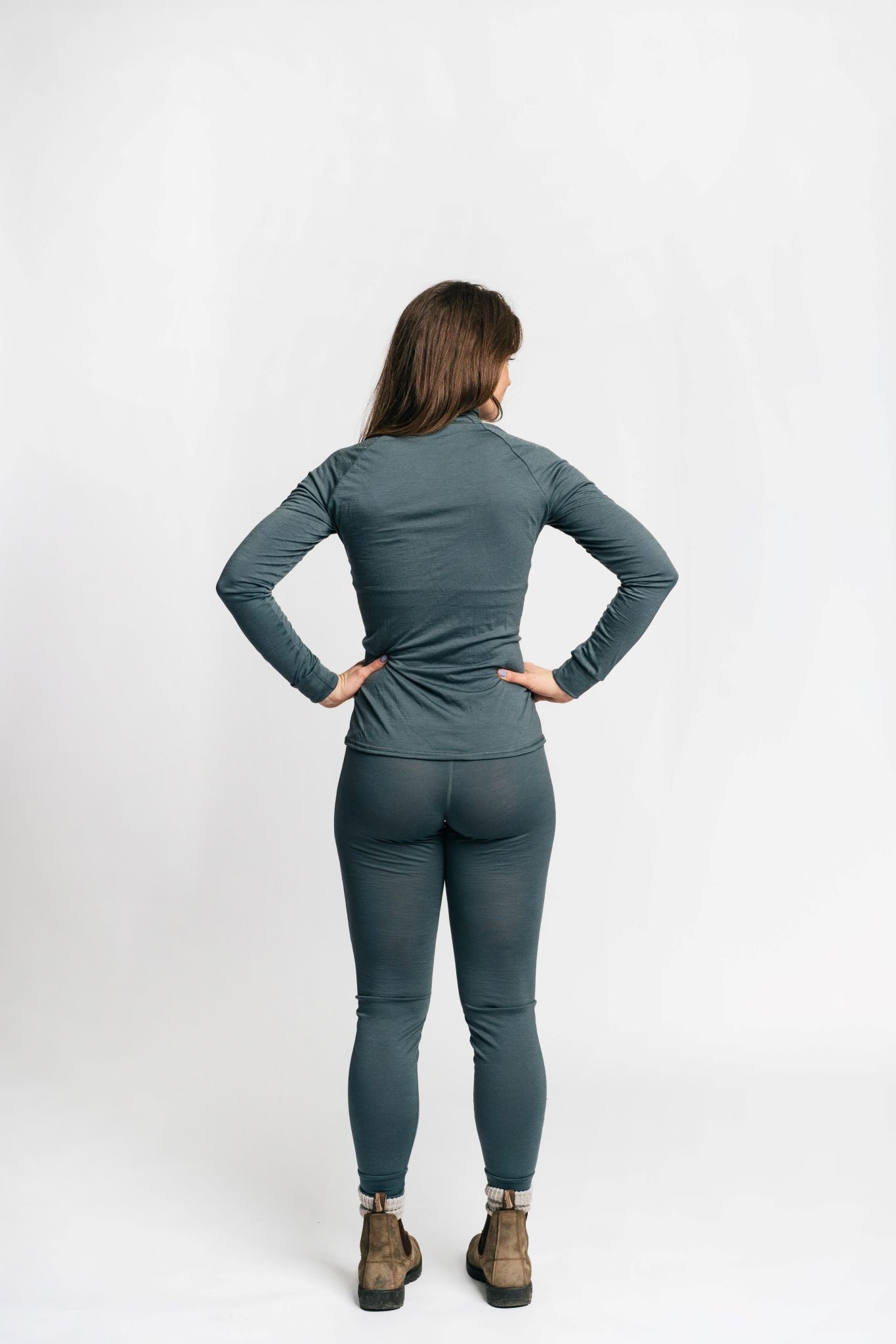 alpine fit merino wool base layer top and bottom on model viewed from the back