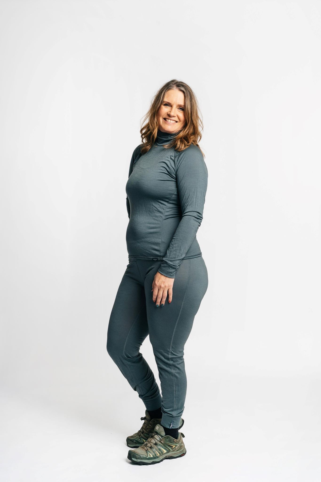 alpine fit merino base layer top and bottom on model side view
