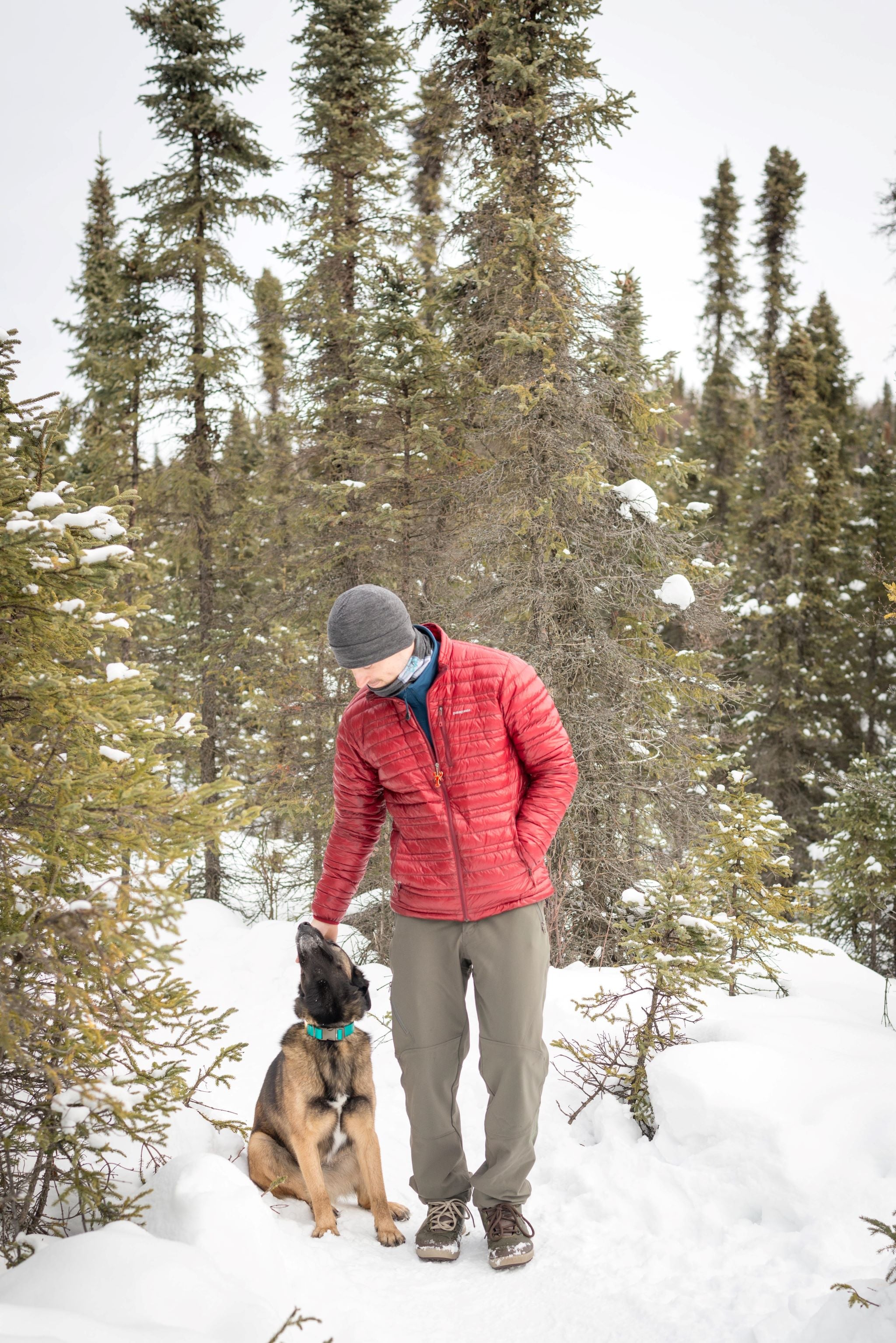 alpine fit merino wool hat on male model outside with dog